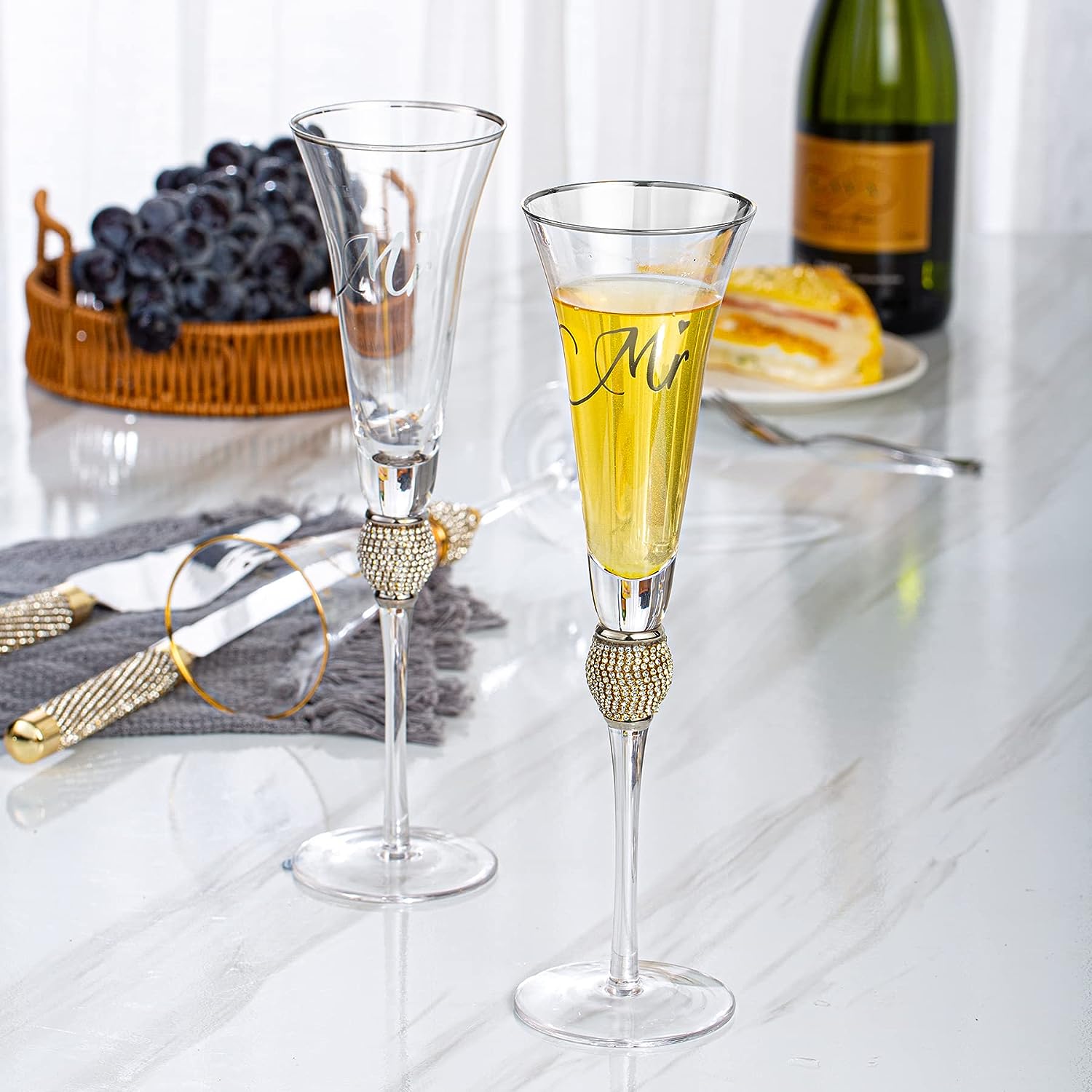 https://varlka.com/cdn/shop/products/champagne-flutes-wedding-cake-knife-and-server-set-toasting-champagne-glasses-with-gold-rim-rhinestone-studded-engraved-mr-and-mrs-couple-bride-and-groom-weddin-608334.jpg?v=1699263612